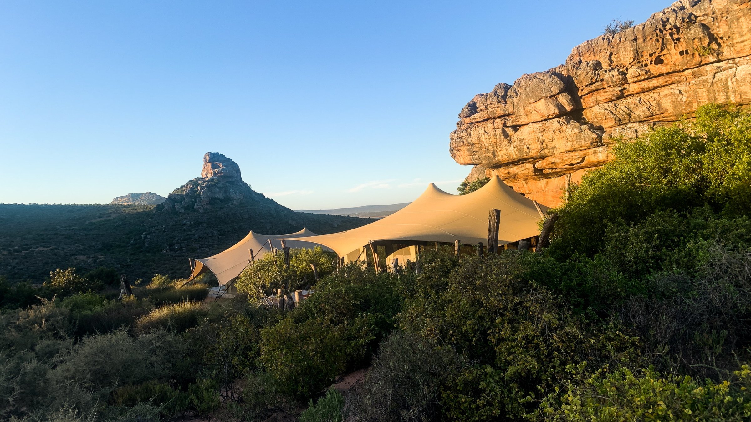 A sunset over the rock formations, the camp below